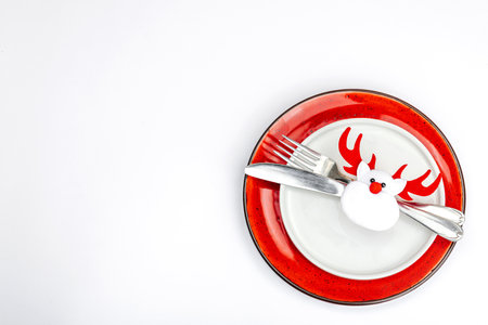 Christmas table setting. New Year cutlery, traditional winter decor, flat lay. Festive cozy mood, minimalist design. Hard light, dark shadow, white background, top viewの写真素材