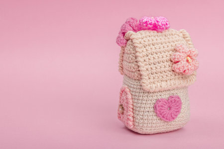 Handmade spring decor concept. Creative crochet, house figurine, traditional flowers and decoration. Festive greeting card, gentle pastel pink background, copy spaceの写真素材