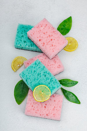 Various sponges for washing dishes. Organic cleaning concept, lemon freshness. Stone concrete...