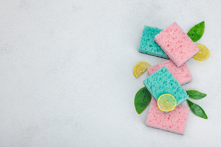 Various sponges for washing dishes. Organic cleaning concept, lemon freshness. Stone concrete...
