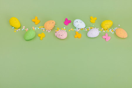 Traditional Happy Easter background, festive edible decor. Homemade baking concept, cute sweets. Greeting card, pastel green, flat lay, top viewの写真素材