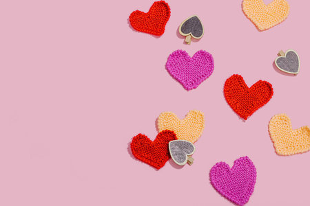 Handmade Valentines Day concept. Creative knitted hearts, spring crafting. Festive greeting card,...