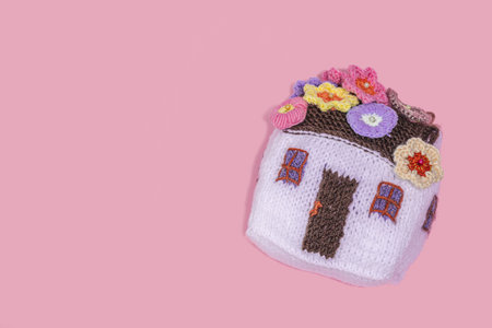 Handmade home spring decor concept. Creative crochet, house figurine, traditional flowers. Festive...