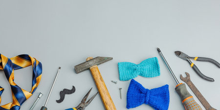 Happy Fathers Day concept. Set of manual tools, tie, spare parts, traditional symbols. Greeting card, flat lay, gray background, banner formatの写真素材