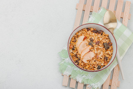 Vegan bowl with tasty cereal granola with dried fruits. Ready to eat food, healthy breakfast concept, good morning style. White stone concrete background, top viewの写真素材