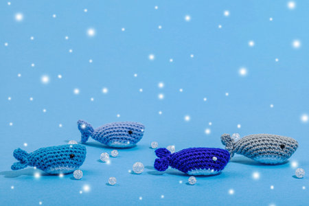 Summer crochet concept. Handmade fishes, marine style. Underwater animals, set of different sharks. Nautical blue background, flat lay, place for textの写真素材
