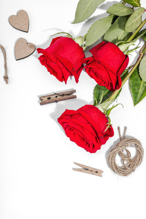 Gift design concept. Decor, special tools, ribbons, cardboard tags on a white background. Handmade, creative space, flat lay, top viewの写真素材