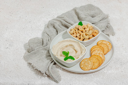 Homemade vegan cashew cheese. Raw healthy sauce in a bowl, lactose free food. Bio organic product,...