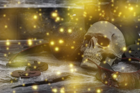 Creepy Halloween composition. Creative background, traditional symbols. Decorative skull, candles, spider web, pumpkins and bats. Dark atmosphere moodの写真素材