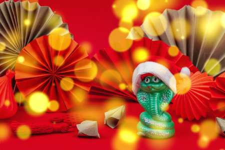 Happy Chinese New Year traditional concept, Zodiac snake symbol. Oriental asian style paper fans on red background, minimal concept, flat lay, copy spaceの写真素材