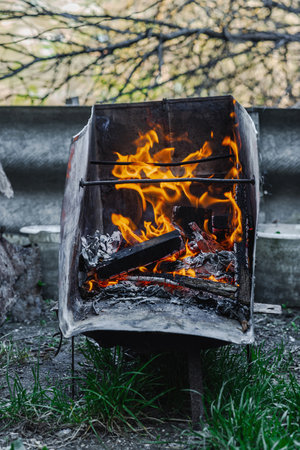 Open flame in a metal container used for heating or cooking in poor living conditions. Reflects urban poverty, displacement, and survival in crisis settingsの写真素材