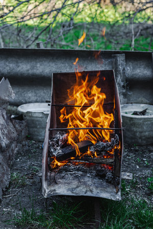 Open flame in a metal container used for heating or cooking in poor living conditions. Reflects urban poverty, displacement, and survival in crisis settingsの写真素材