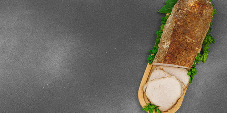 High-protein roasted pork loin served with flavor spices, styled for food photography. Suitable for keto and paleo diets, black stone background, banner formatの写真素材