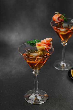 Stylish salmon martini cocktail served with smoked salmon, olive, lemon, and dill. High-end mixology trend. Perfect for bar menus, lifestyle or gourmet drink features, copy spaceの写真素材