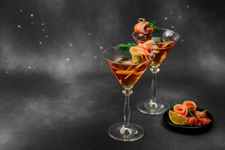 Stylish salmon martini cocktail served with smoked salmon, olive, lemon, and dill. High-end mixology trend. Perfect for bar menus, lifestyle or gourmet drink features, copy spaceの写真素材