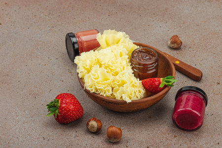 Cheese assortment on rustic background with nuts, strawberries and jam.の写真素材