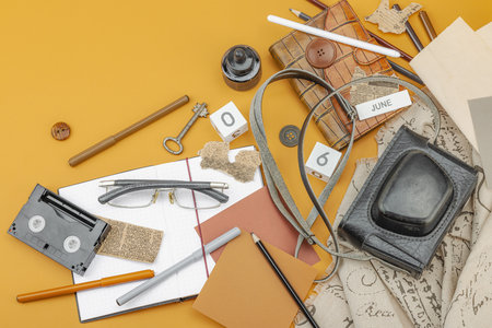 Flat lay composition with vintage journalism tools, symbolizing press freedom, OSINT and Journalist's Day in Ukraine. Retro elements, analog camera on ochre background, top viewの写真素材