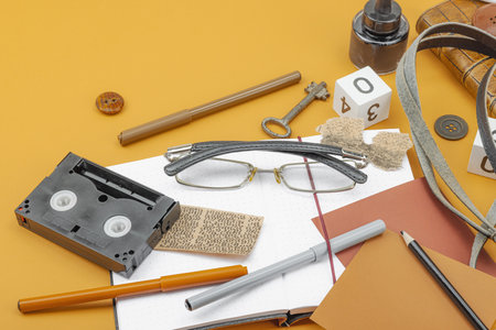 Flat lay composition with vintage journalism tools, symbolizing press freedom, OSINT and Journalist's Day in Ukraine. Retro elements, analog camera on ocher background, copy spaceの写真素材