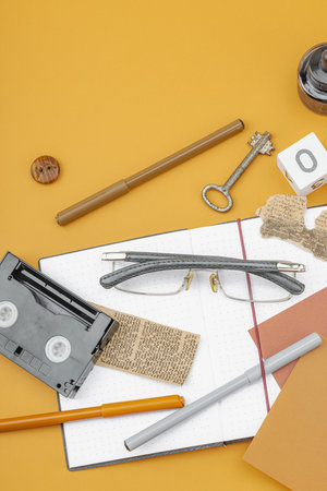 Flat lay composition with vintage journalism tools, symbolizing press freedom, OSINT and Journalist's Day in Ukraine. Retro elements, analog camera on ochre background, top viewの写真素材