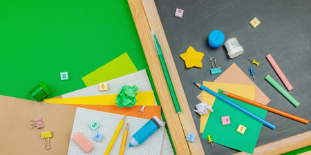 Eco-friendly flat lay with school supplies, wooden toys on green background. Zero waste lifestyle...