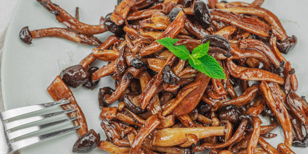 Fried Shimeji mushrooms with spices and herbs on a trendy plate. Vegan lifestyle concept, light...