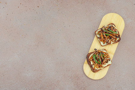 Healthy plant-based open sandwiches with sautÃ©ed Shimeji mushrooms. Protein rich vegan meal is...