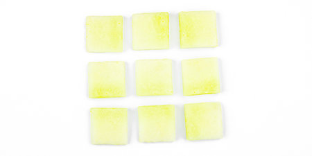 Geometric pattern of melon pieces cut into squares, circles, and triangles. Abstract design on a...
