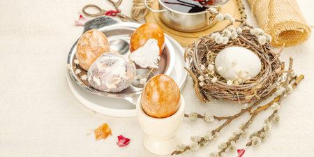 Still life with marble-patterned Easter eggs in a decorative birds nest. Natural dyes from onion...