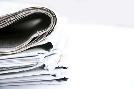 Isolated bunch of newspapers on white backgroundの写真素材