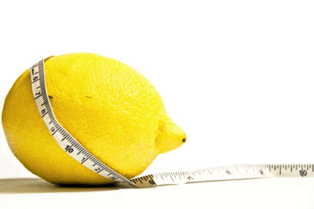 Isolated lemon and ruler on white backgroundの写真素材
