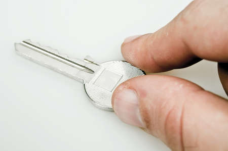 Male hand holding a keyの写真素材