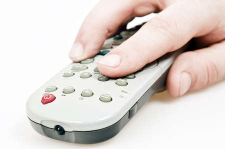 Male hand holding tv remote controlの写真素材