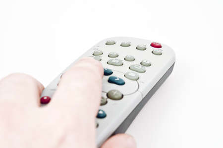 Male hand holding tv remote controlの写真素材