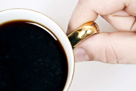 Male hand holding cup of coffeeの写真素材