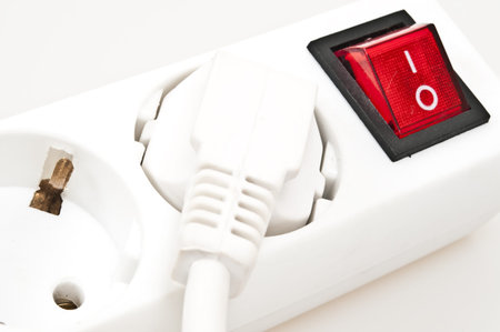 Isolated power outlet with red button 