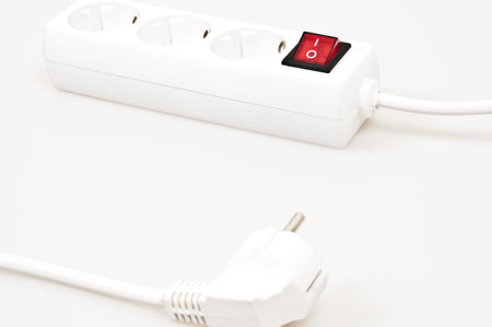 Isolated power outlet with red button 