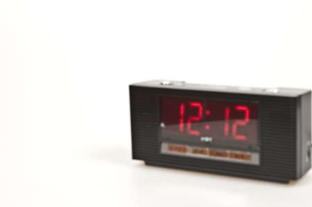 Blured clock showing 12:12 isolated on white backgroundの写真素材