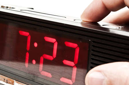 Male hand stopping alarm clockの写真素材
