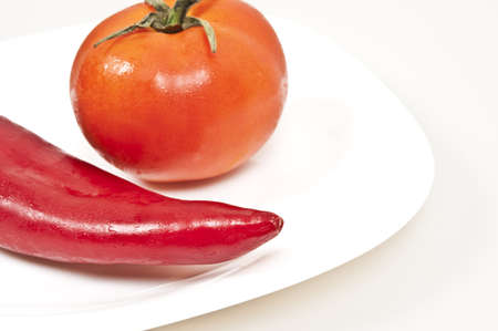 Isolated red pepper and tomato on white backgroundの写真素材