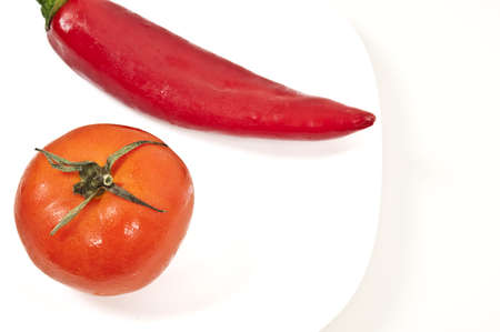 Isolated red pepper and tomato on white backgroundの写真素材
