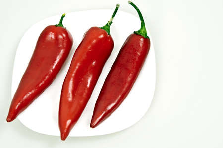 Isolated group of red peppers on white backgroundの写真素材
