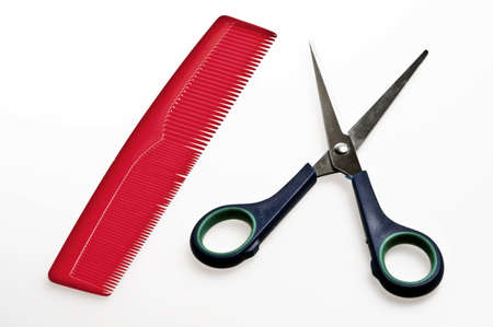 isolated red comb and blue scissorsの写真素材