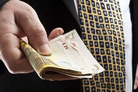 Business man offering bunch of euro banknotesの写真素材