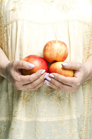 Housewife holding bunch of applesの写真素材