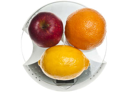 Mix of fruits isolated on food scaleの写真素材