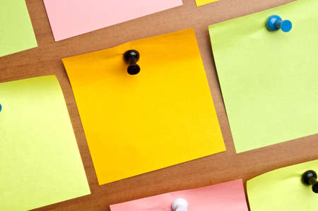 Empty orange post it on wooden wallの写真素材