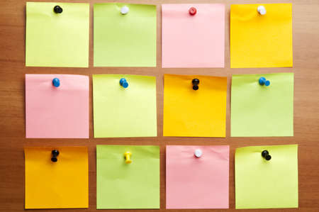 Twelve empty post it on wooden wallの写真素材