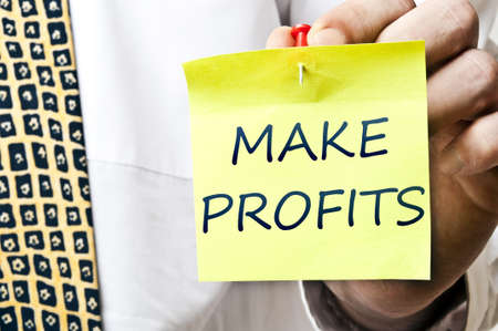 Make profits post it ready to be posted by businessman handの写真素材