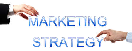 Marketing strategy words made by business woman and man handsの写真素材