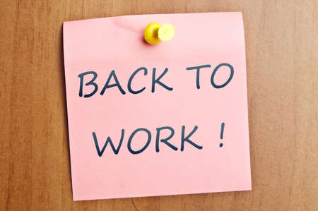 Back to work post it on wooden wallの写真素材